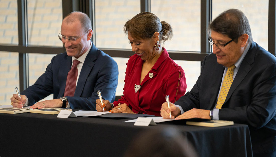 leaders from Texas A&M Health, University Health Services and A&M-San Antonio sign documents at a cermony