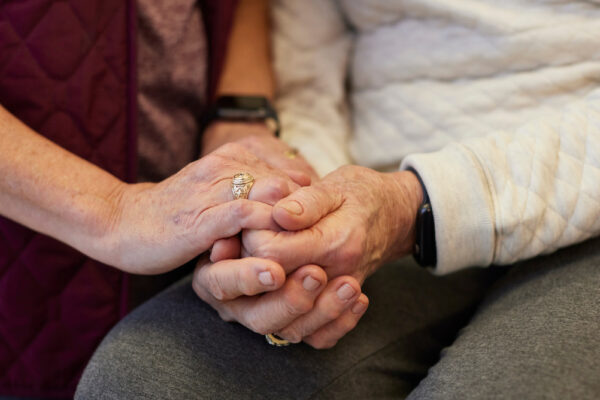 Caregiver Holding The Hands Of An Older Adult