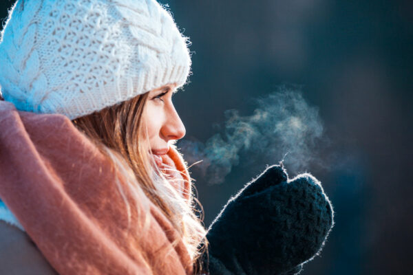 Woman Rubs Mittened Hands Together In Cold Air