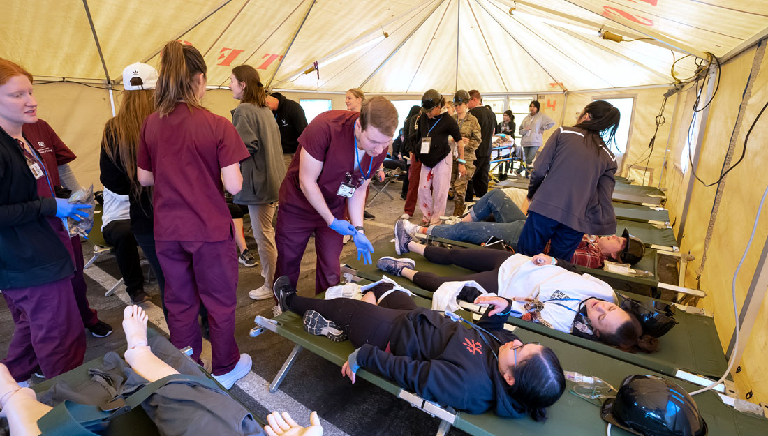 Health profession students perform triage at a field hospital during the Texas A&M Health Disaster Day emergency response simulation on March 3