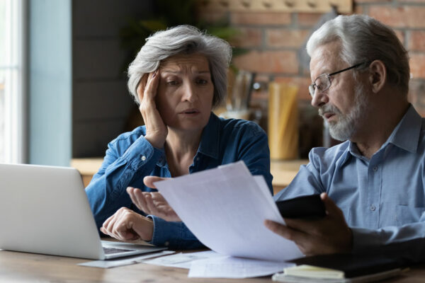 Older Couple Looks Worried Over Paying Bills