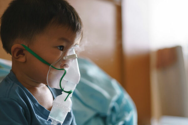 Boy Sittin Gin Hospital Bed Uses Nebulizer