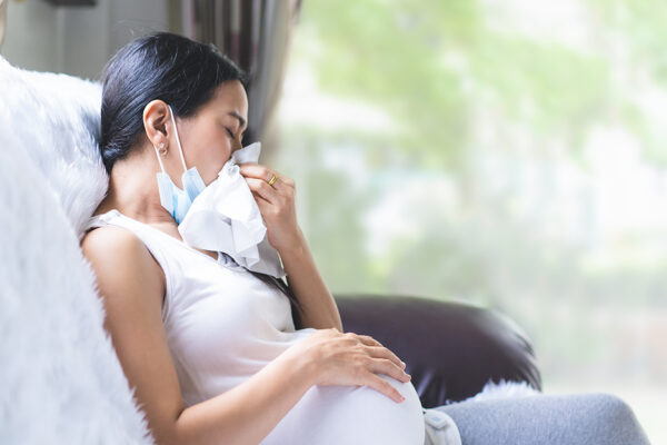 Pregnant Woman Blows Her Nose Into A Tissue