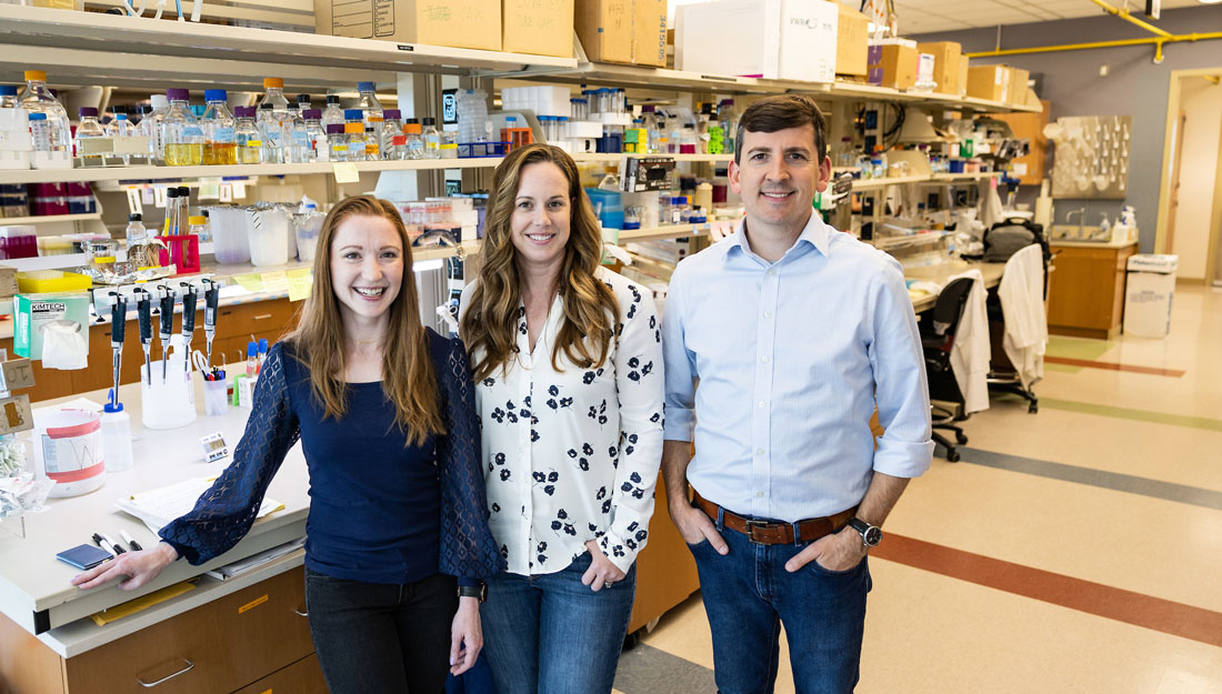 Lauren Farris, Jenny Hyde, PhD, and Phillip West, PhD, stand together in a laboratory