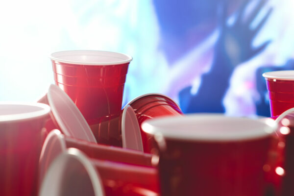 Many Red Solo Cups With Party Blurred In The Background