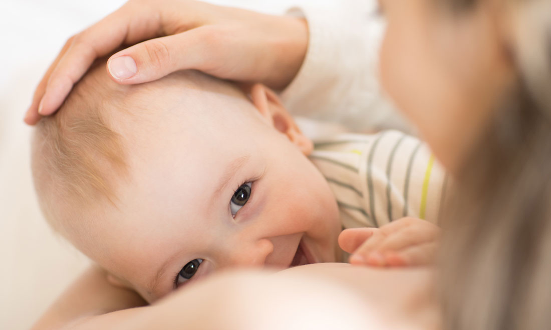 breastfeeding baby smiles