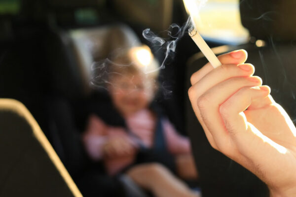 Woman With Cigarette And Child In Car