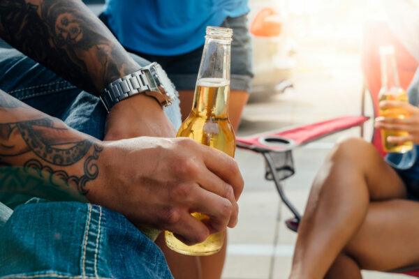 People Holding Beer Bottles