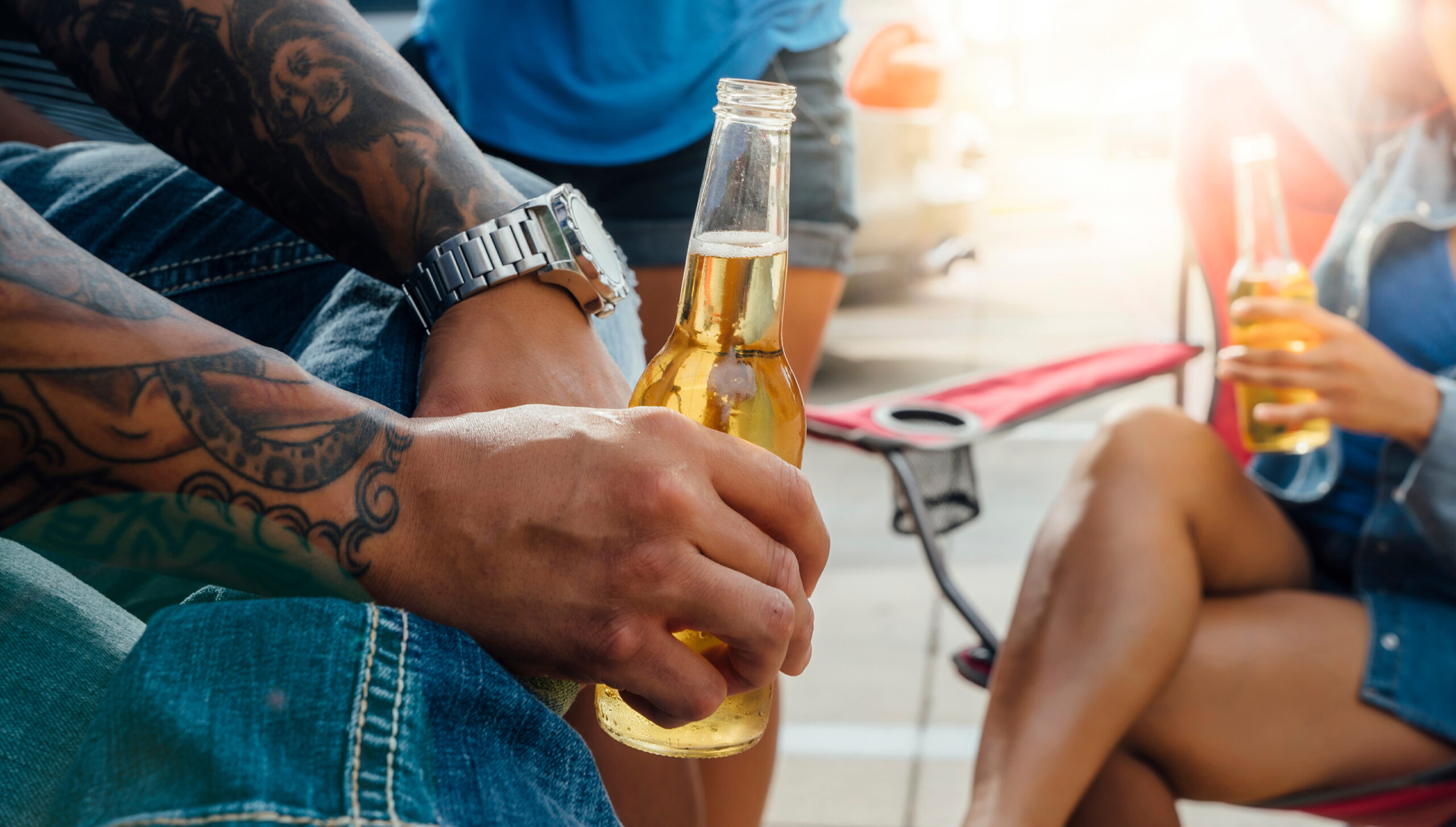 people holding beer bottles