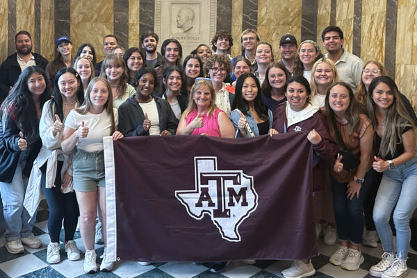 SPH Study Abroad Students Holding Texas A&M Banner