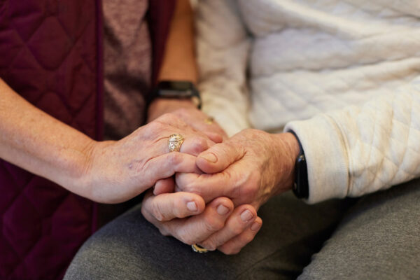 Woman Wearing Aggie Ring Holds Hands Of An Older Woman