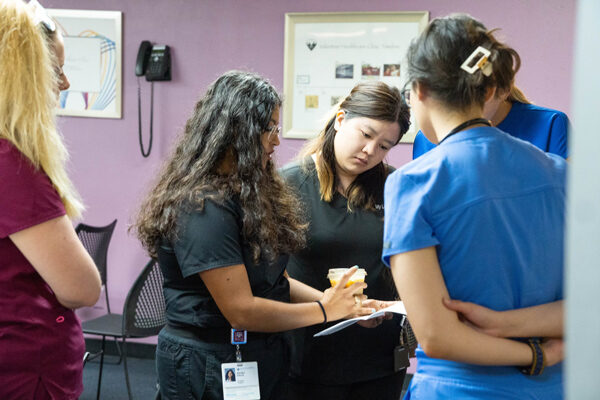 health care students review a chart together