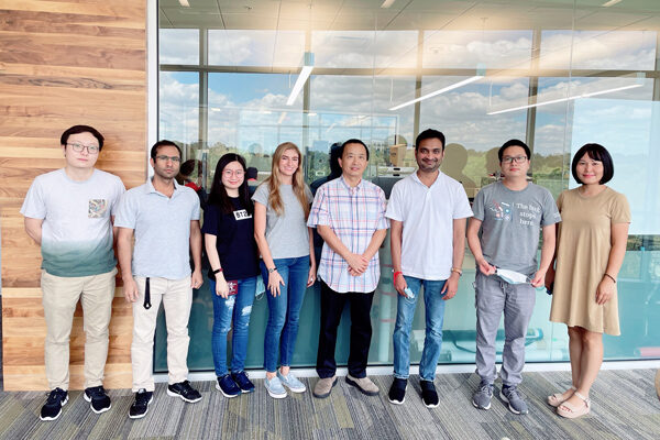 group of eight people pose for a group photo