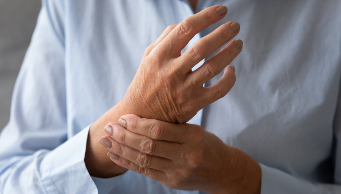 older woman massaging her hand