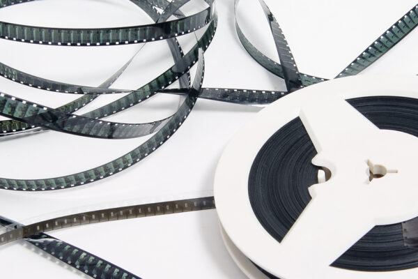 Tangle Of Old Film Strip Unspooling From Reel