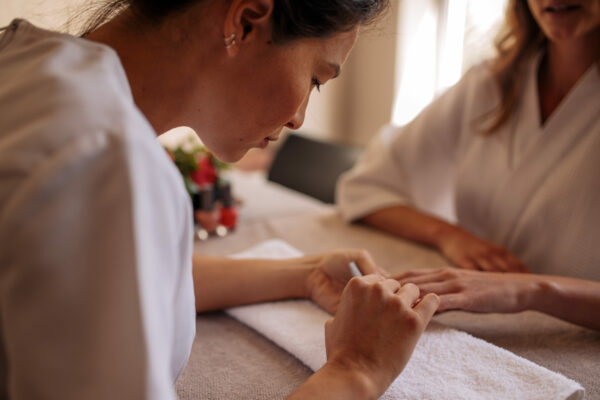 Beauty Service Worker Performs A Manicure