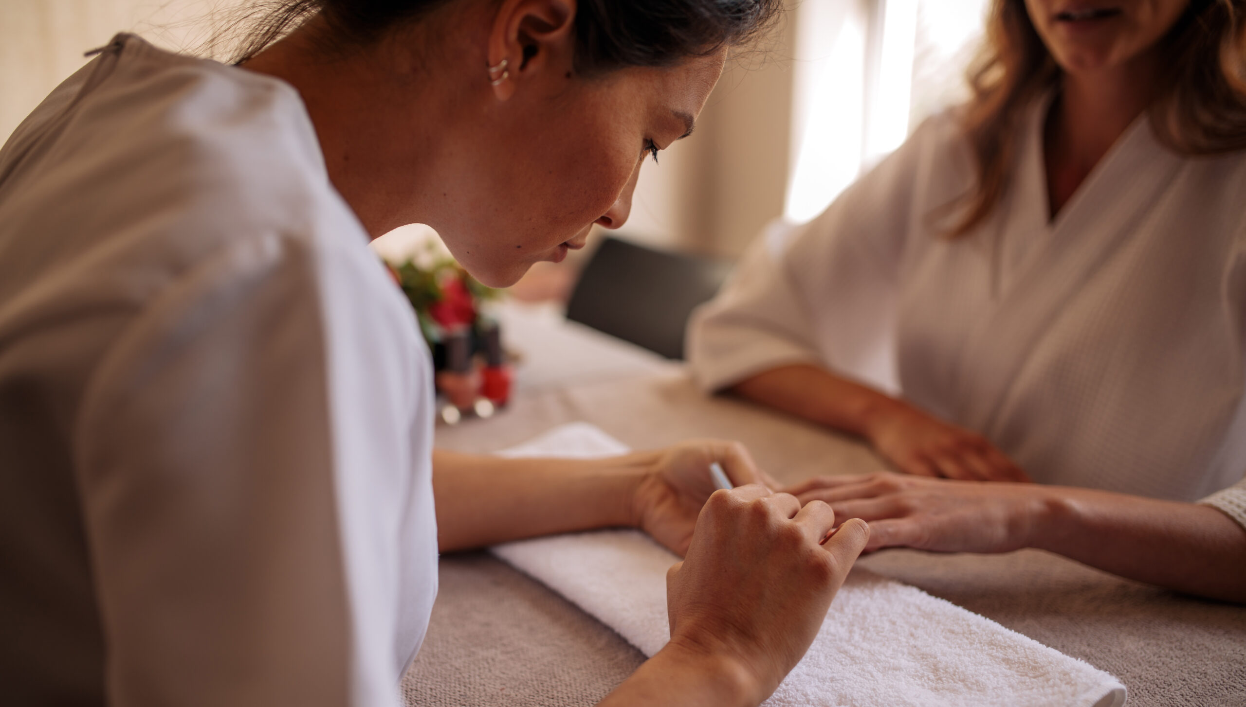 beauty service worker performs a manicure