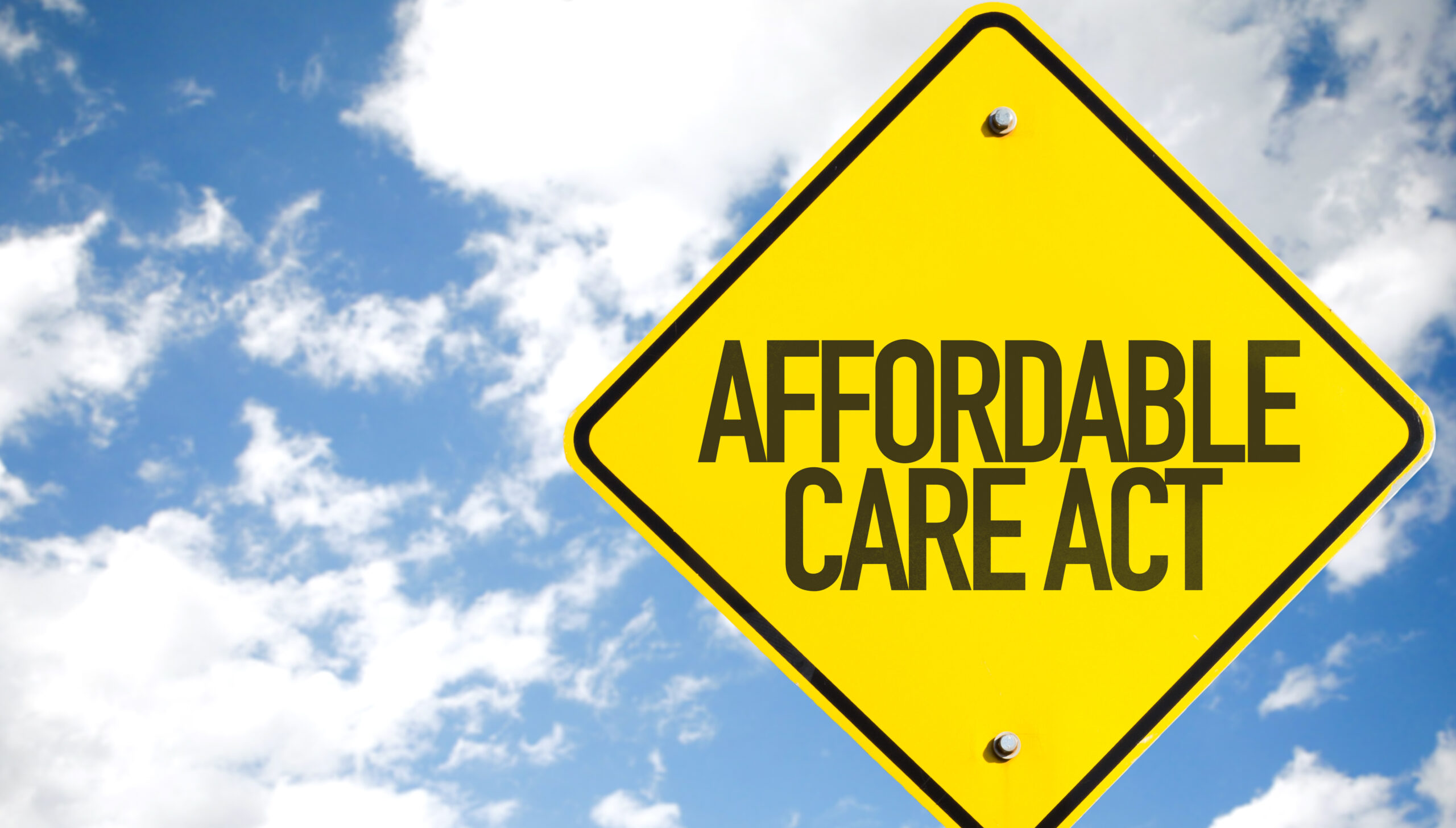 Affordable Care Act sign with sky background; rural and urban ACA