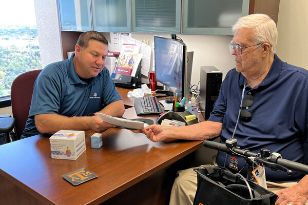 Health professional consults with a patient in office