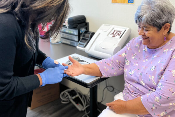 Older Woman Receives Blood Glucose Check From A Health Care Professional During Diabetes Management Appointment