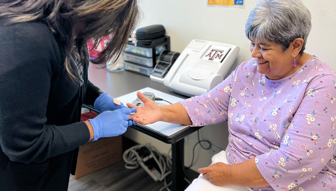 older woman receives blood glucose check from a health care professional during diabetes management appointment