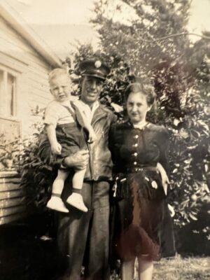 black and white image of a man, woman and young child