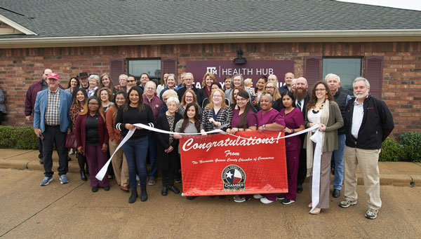 a group of leaders do a ceremonial ribbon cutting at the Texas A&M Health Hub in Navasota