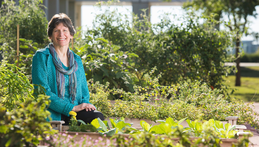 Marcia Ory sits in a garden