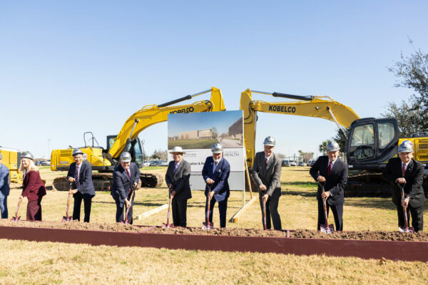 Men And Women In Suits Take Part In A Shovel Ceremony