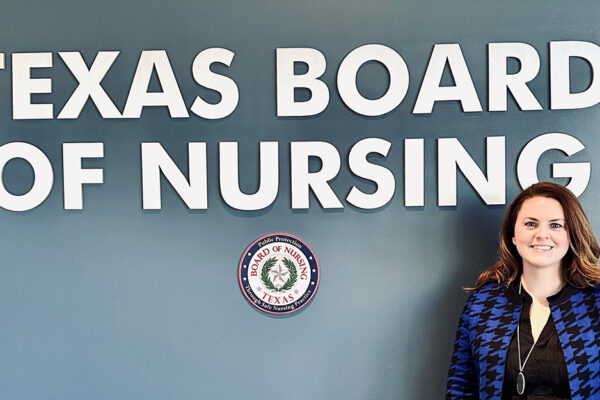 Elise McDermott In Front Of Texas Board Of Nursing Sign