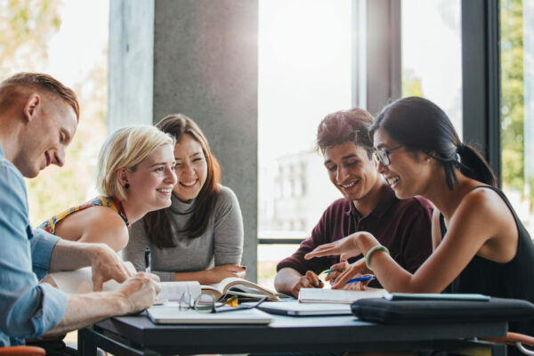 Group Of Students Studying In College Library