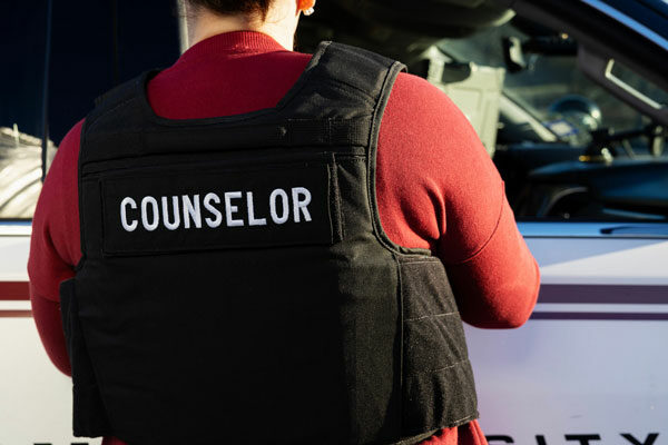 close up on the back of a kevlar vest with the word, "counselor" on it