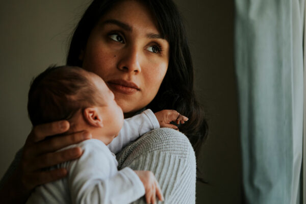 Mother Holding Her Newborn Baby Indoor