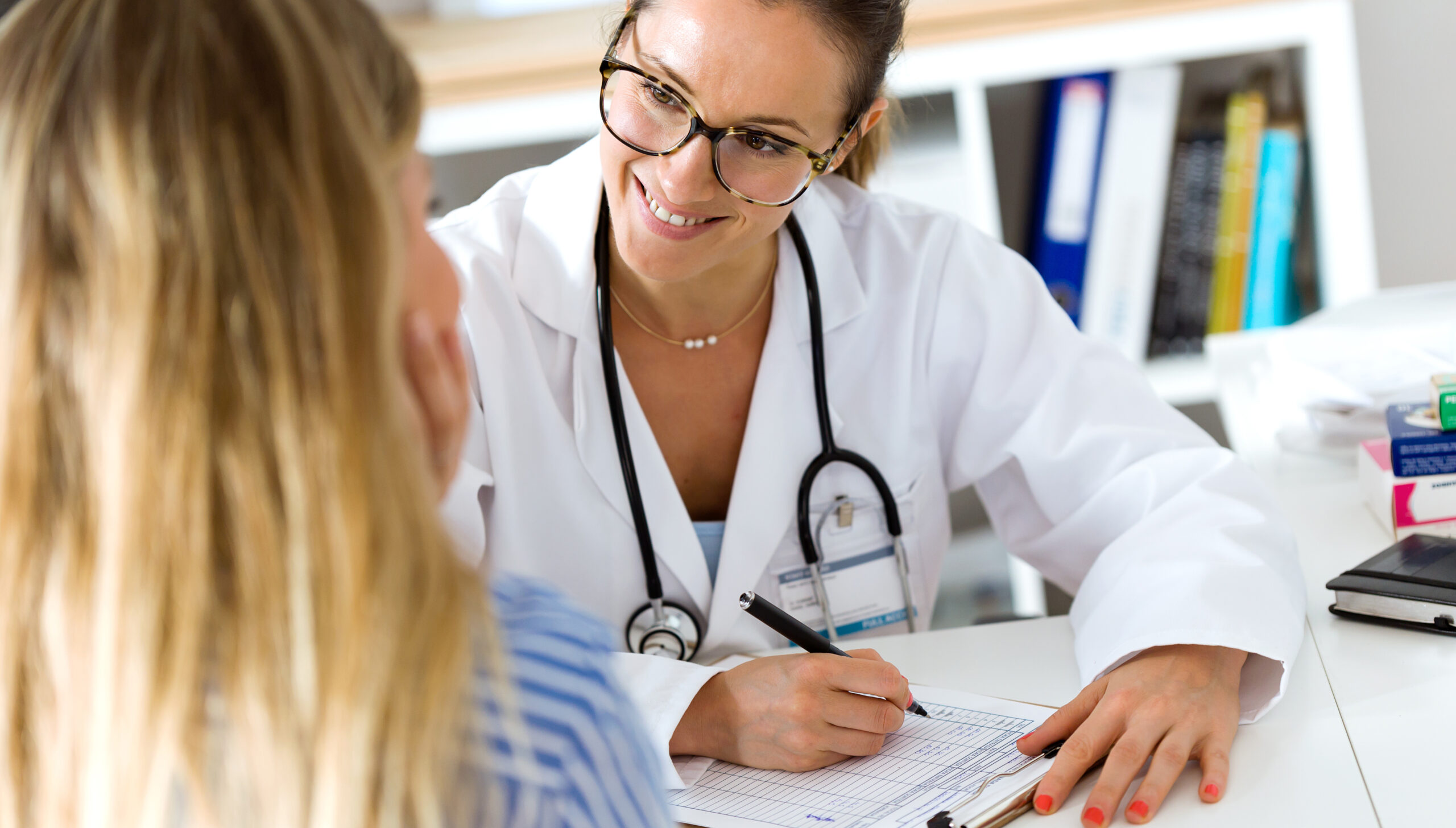 Female doctor explaining diagnosis to her patient.