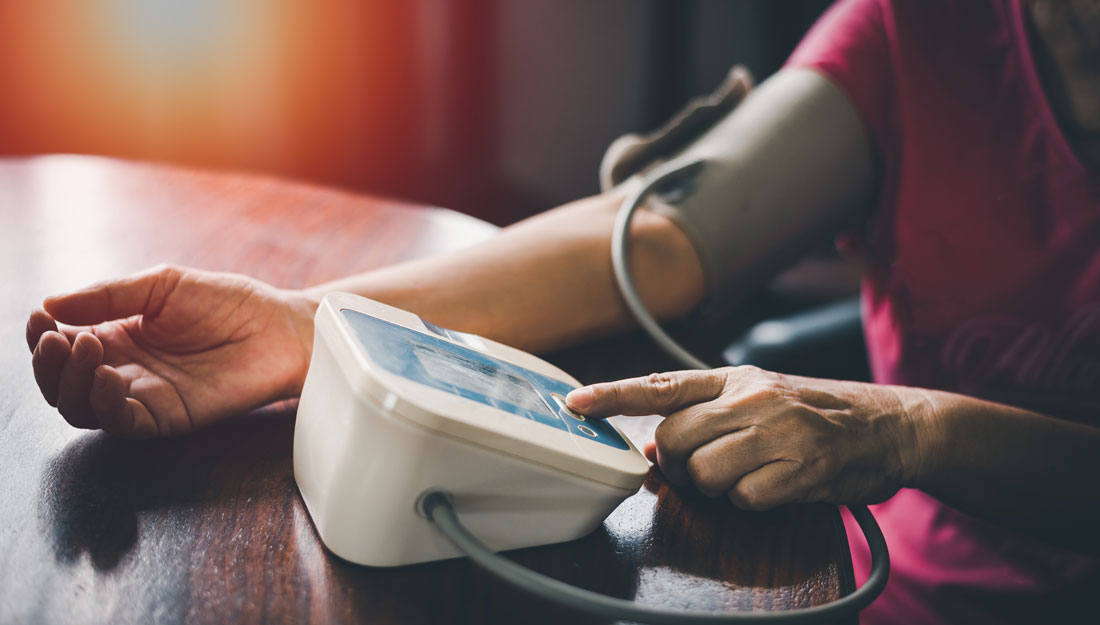 person checking blood pressure at home