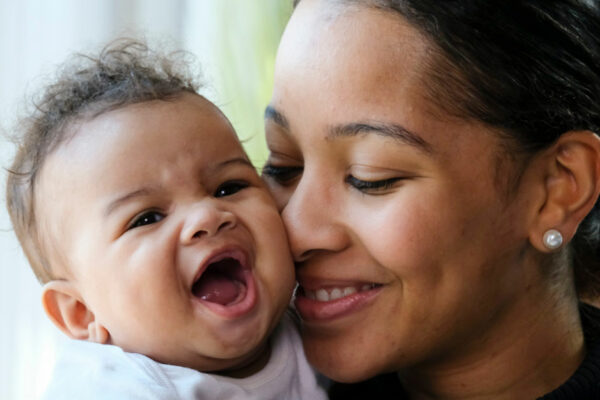 Close Up Portrait Of Black Woman Holding A Baby Girl