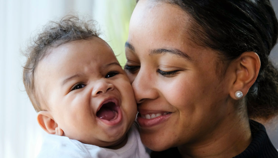 Close up portrait of Black woman holding a baby girl