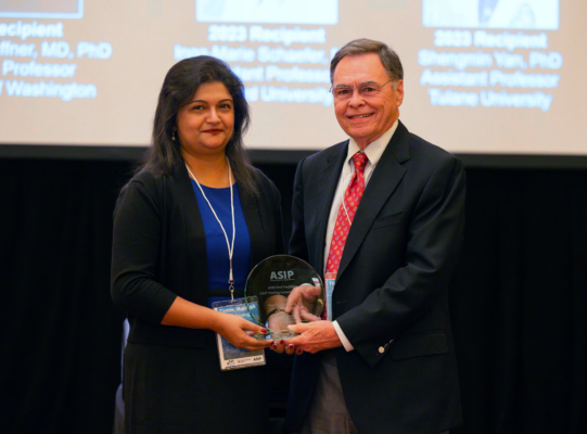 Sanjukta Chakraborty and Dr. Fred Sanfilippo hold an award