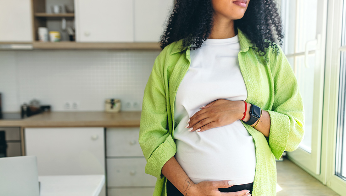 Pregnant woman caressing her stomach