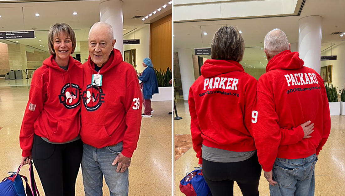 Martha Parker and George Packard stand together wearing matching sweatshirts