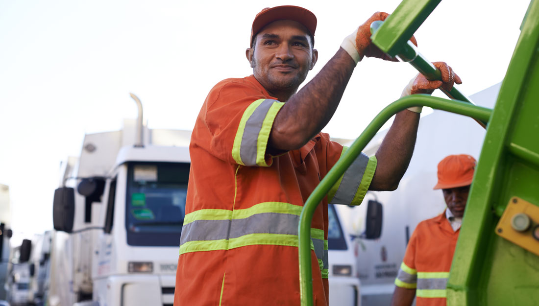 Cropped shot of a team of solid waste workers on a garbage collection vehicle