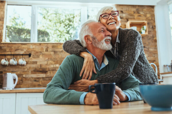 Older Woman Embraces An Older Man