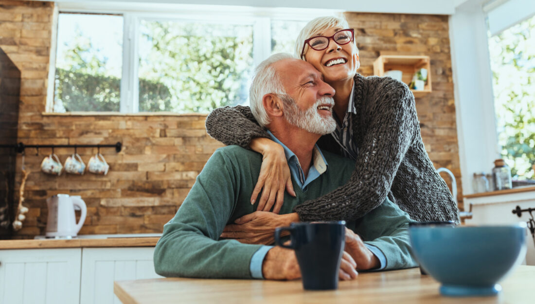 Older woman embraces an older man