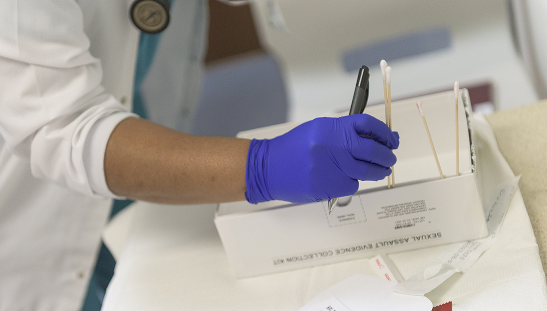 Nurse with sexual assault evidence collection kit