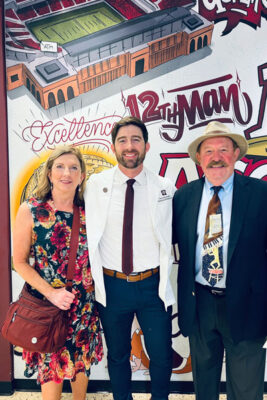 Pat Monday stands with his parents after receiving his white coat from the Texas A&M College of Medicine