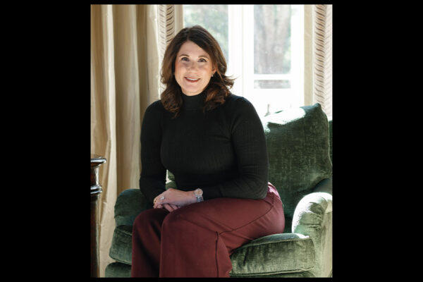 Rachel Moore Sits On A Chair, Smiling