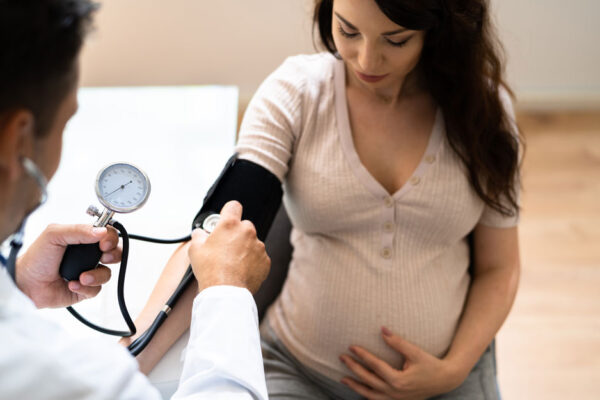 Doctor Measuring Blood Pressure Of Pregnant Woman