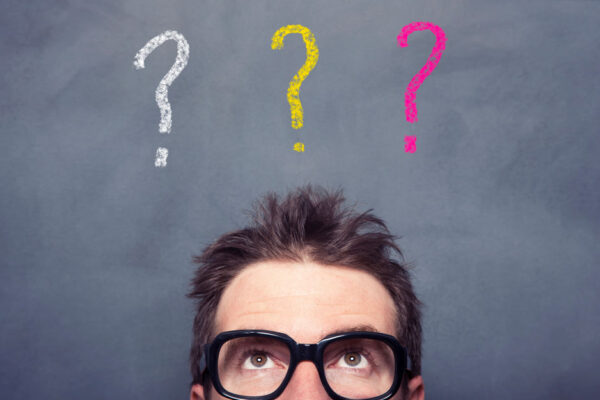 Man Looks Up Toward Three Question Marks Over His Head