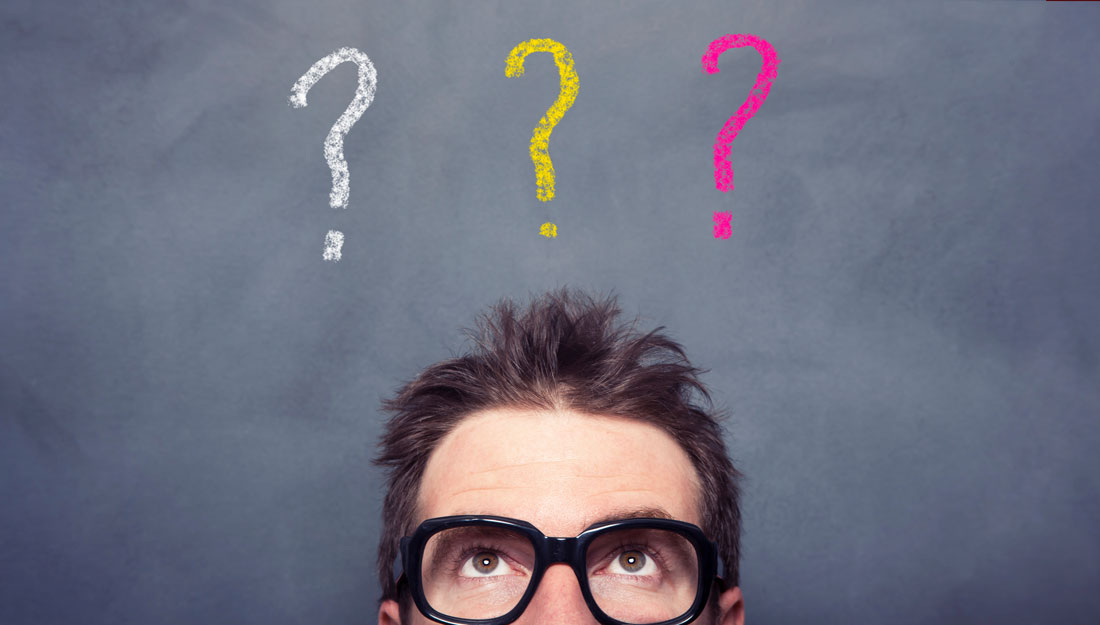 man looks up toward three question marks over his head