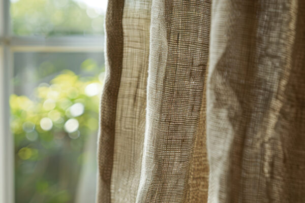 Close Up Of Yellowed Curtain Against A Window